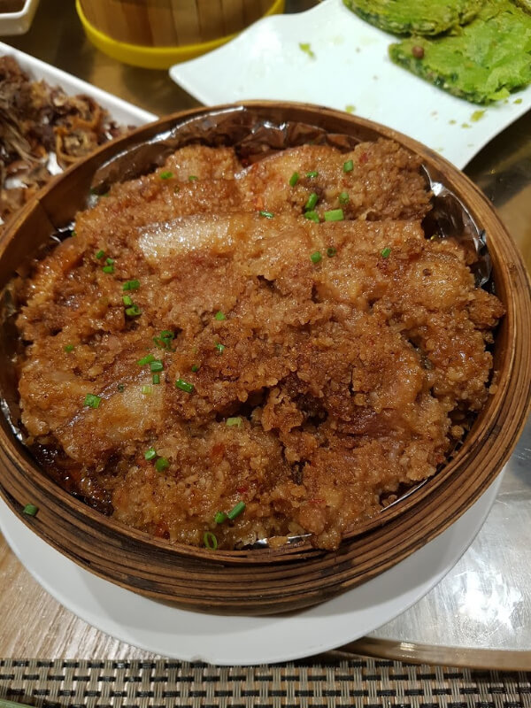 a wooden dish of pork 