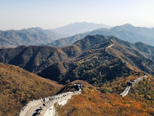 the great wall of China with mountains and trees with the leaves changing color : Top 10 Travel Moments of 2019