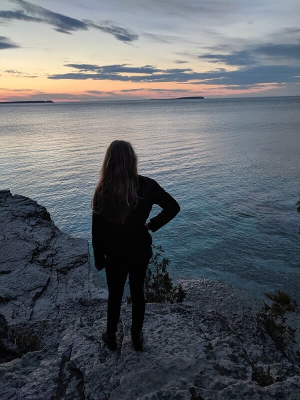 A girl watching the sunset at Cyprus Lake in Tobermory.