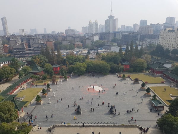 A view from the top floor of the Tengwang Pavilion in Nanchang. You can see buildings and people. 