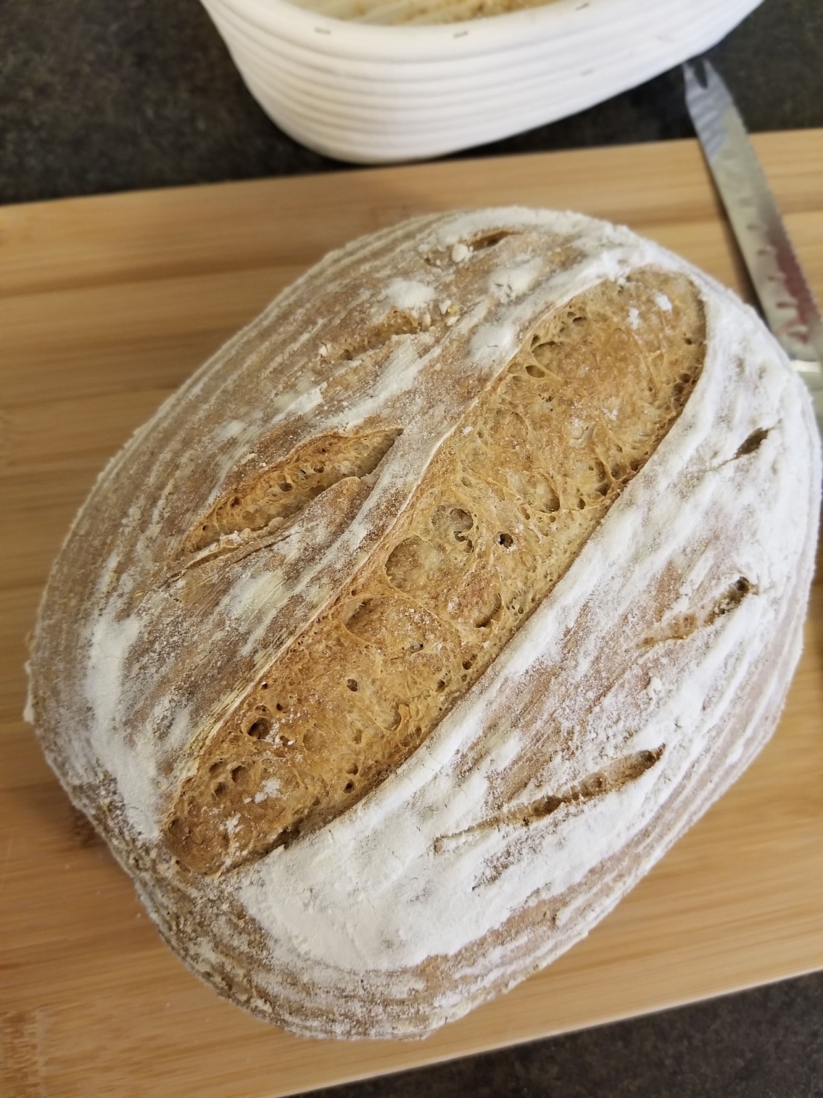 A loaf of sourdough bread on a cutting board. 