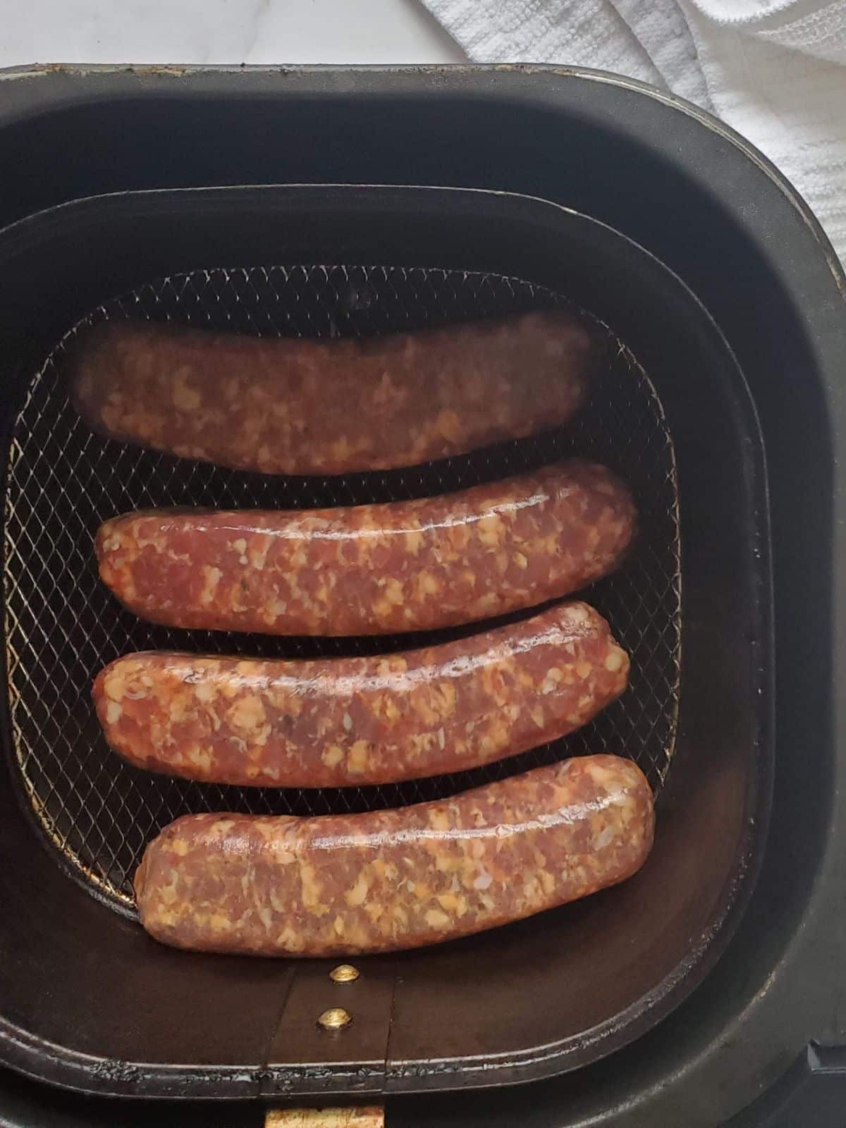 4 raw Italian sausages in the air fryer. 