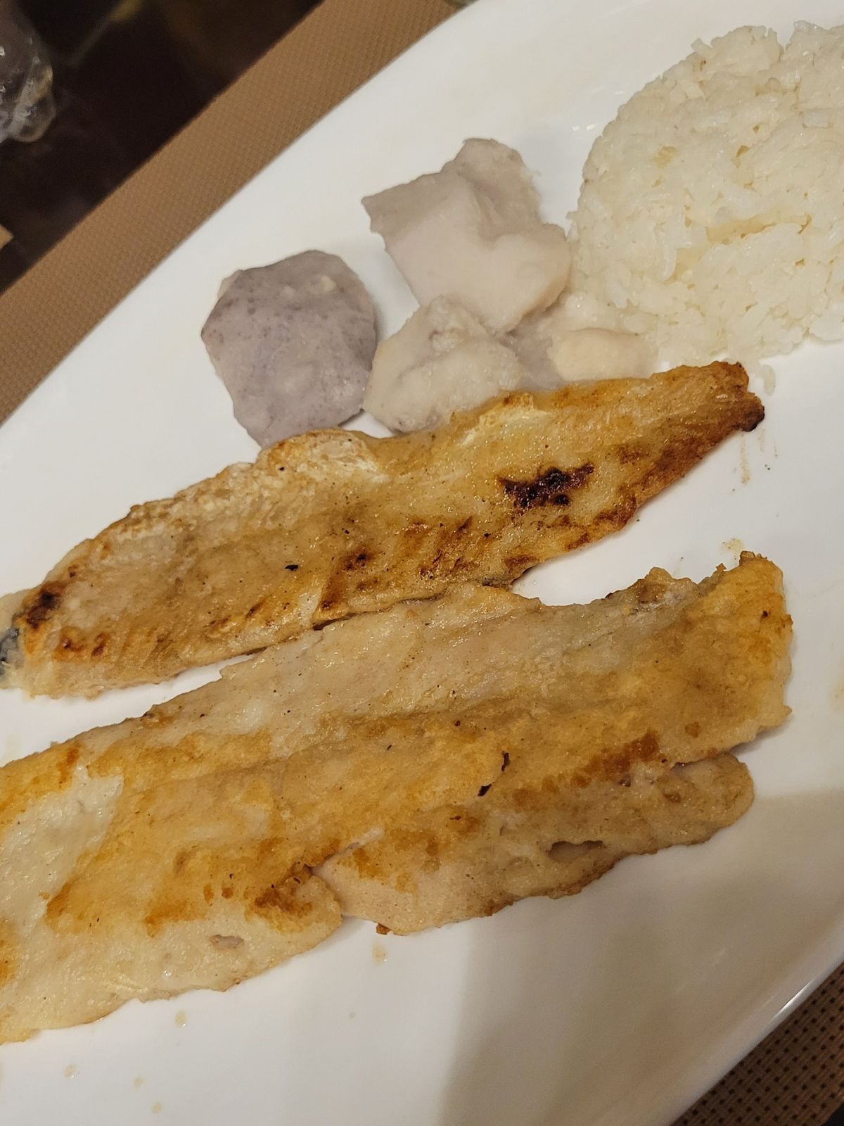 A plate of fish and rice and cassava. 